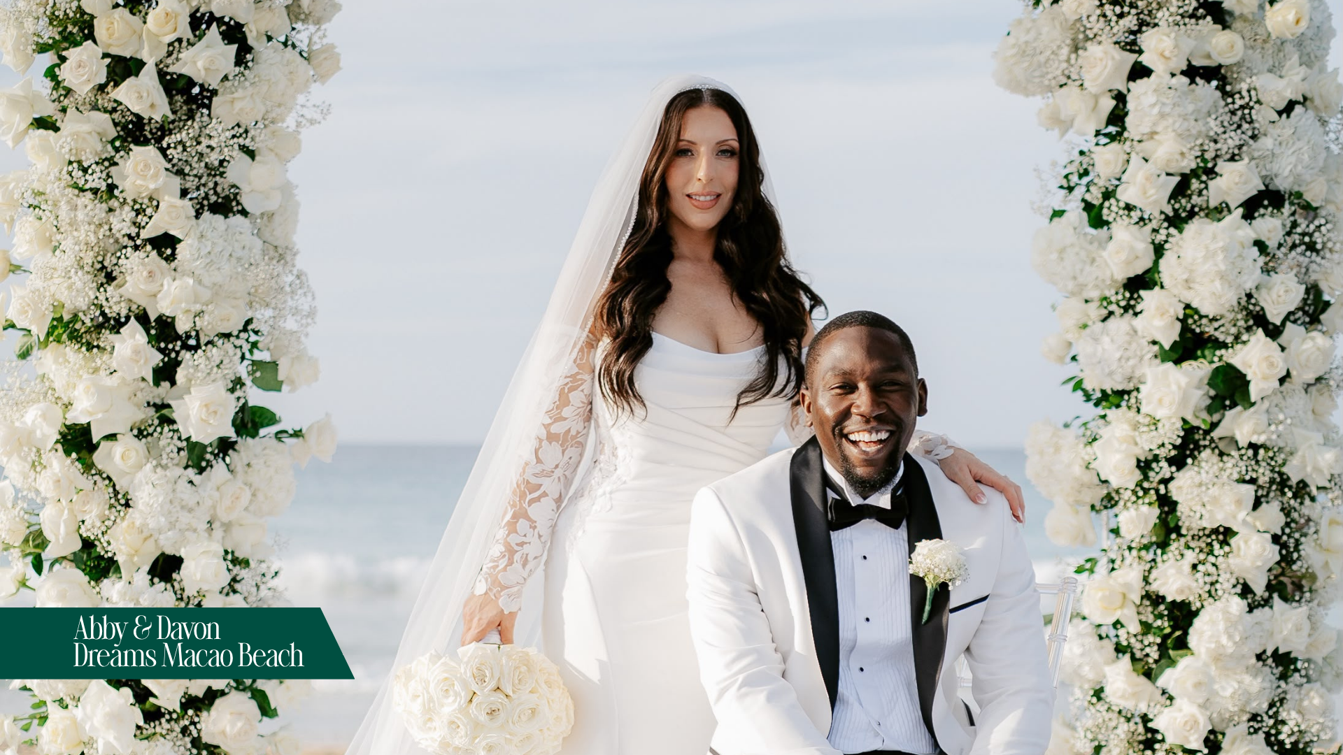 Abby & Davon bridal couple sitting at floral-covered chuppah on their wedding day